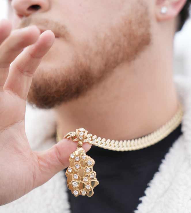 Man showcasing gold chain with diamond pendant by WJD Exclusives
