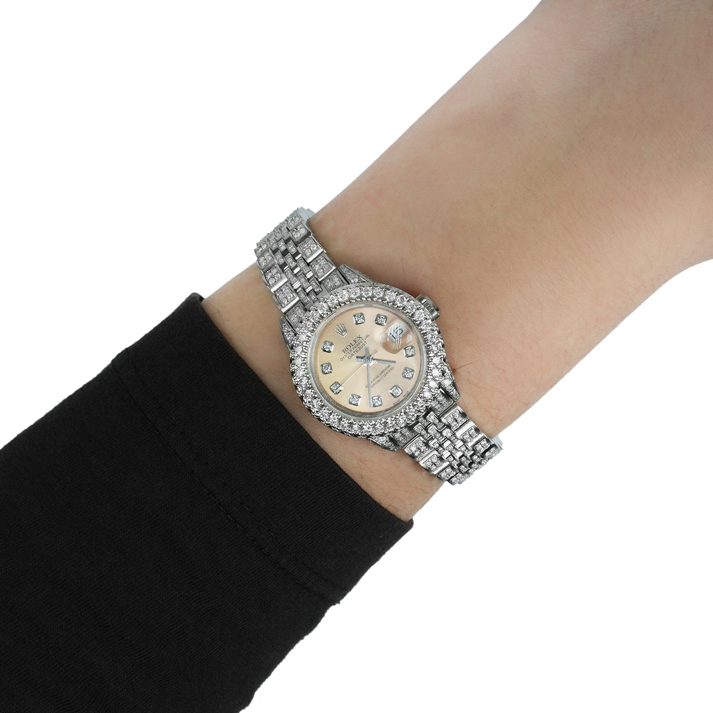 Silver wristwatch with a detailed face on a person's wrist against a white background [lifestyle]