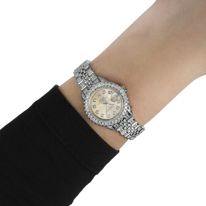 Silver wristwatch with a detailed face on a person's wrist against a white background [lifestyle]