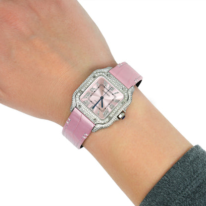Pink watch with diamond accents on a wrist against a white background [lifestyle]