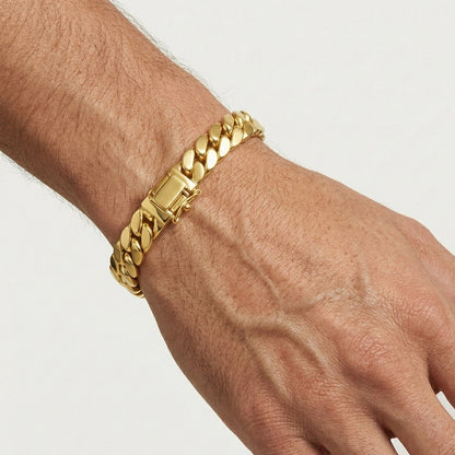 Gold chain bracelet on a wrist against a neutral background [lifestyle]