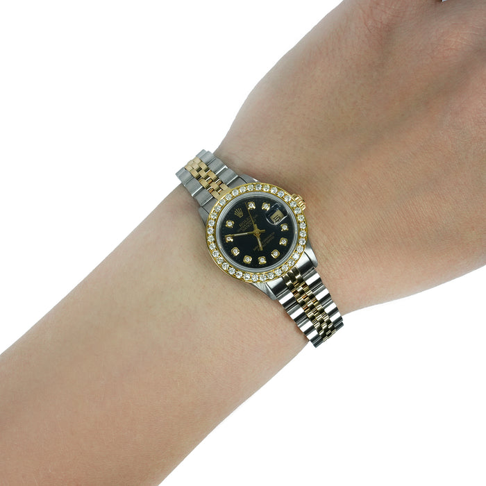 Gold and silver watch on a wrist with a white background [lifestyle]