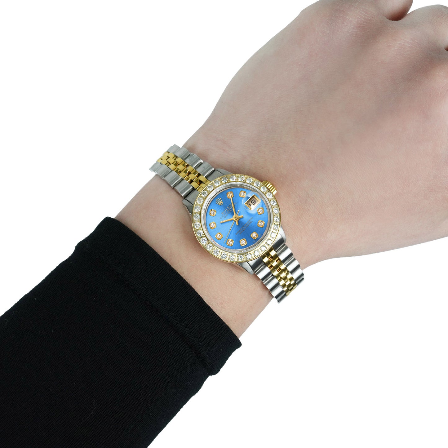 Gold and silver watch with a blue face on a wrist against a white background [lifestyle]
