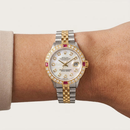 Luxury watch with a two-tone metal band on a wrist against a neutral background [lifestyle]