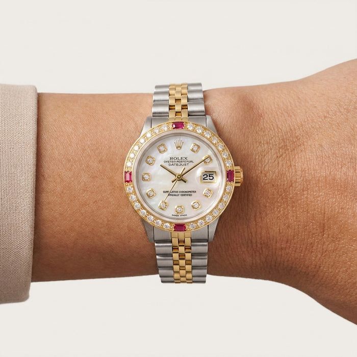 Luxury watch with a two-tone metal band on a wrist against a neutral background [lifestyle]