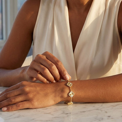 Person wearing a gold bracelet on a marble surface with a blurred background [lifestyle]