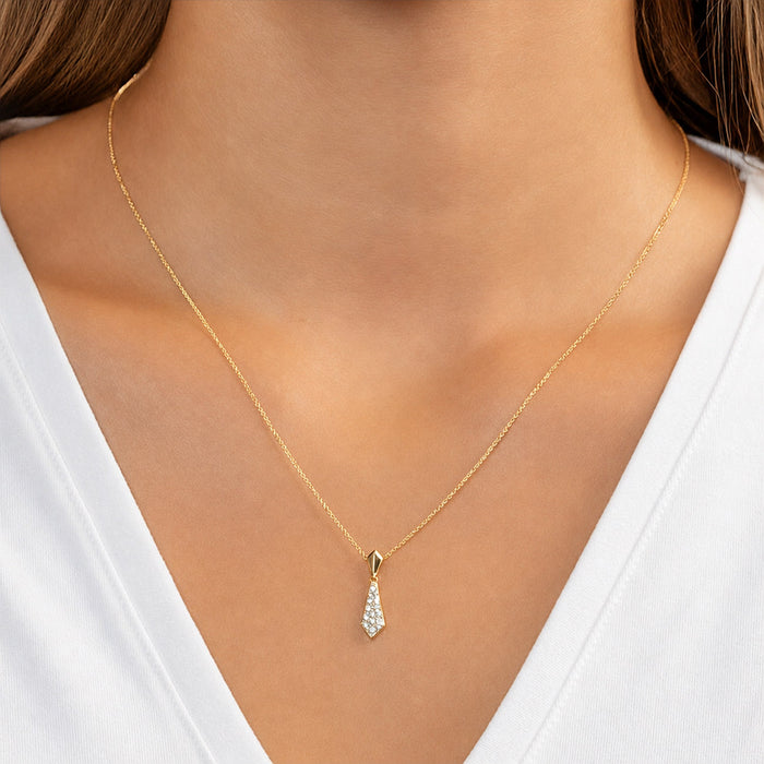 Gold necklace with a teardrop-shaped pendant on a person wearing a white top. [lifestyle]