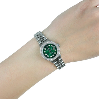 Silver watch with a green face on a wrist against a white background [lifestyle]