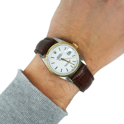 Watch with a brown leather strap on a wrist against a white background [lifestyle]