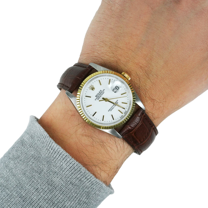Watch with a brown leather strap on a wrist against a white background [lifestyle]