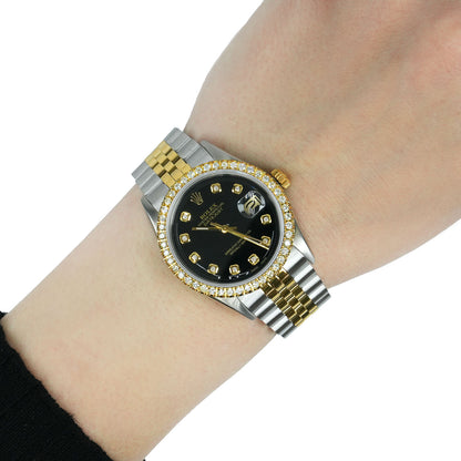 Luxury watch with black face and gold accents on a wrist against a white background [lifestyle]