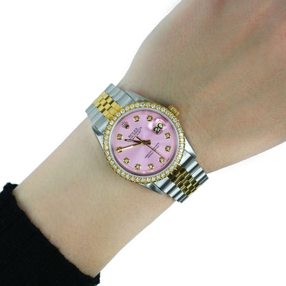 Luxury watch with pink face and gold accents on a wrist against a white background [lifestyle]