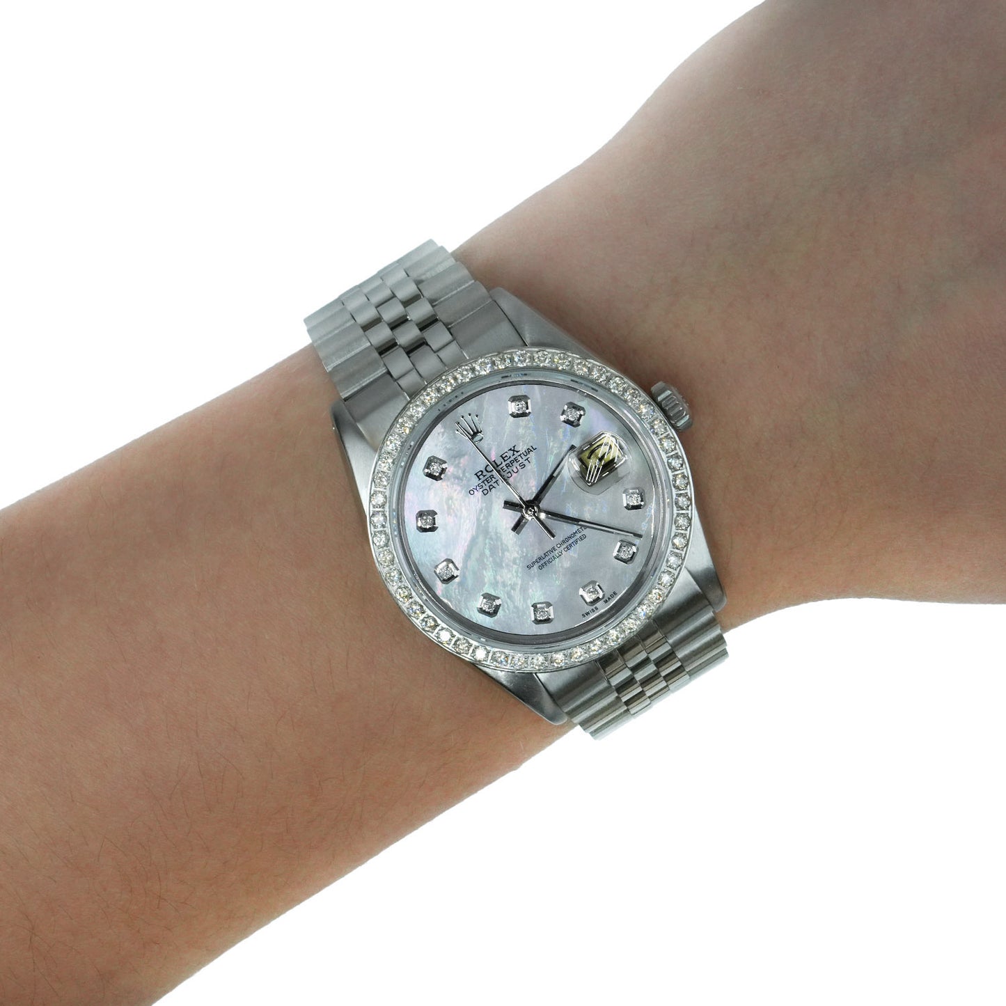 A silver-tone Rolex Datejust watch with a mother-of-pearl dial and diamond hour markers, shown worn on a wrist against a white background. [lifestyle]
