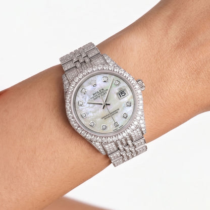 Silver wristwatch with diamond accents on a wrist against a white background [lifestyle]