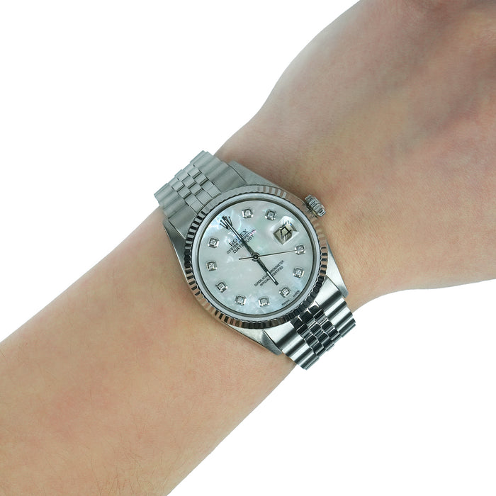 Silver wristwatch with a diamond-studded face on a wrist against a white background [lifestyle]