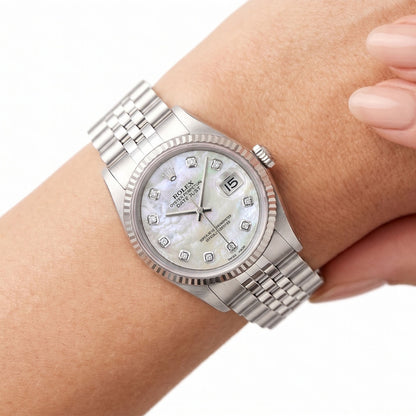 Silver wristwatch with a diamond-studded face on a wrist against a white background [ifestyle]