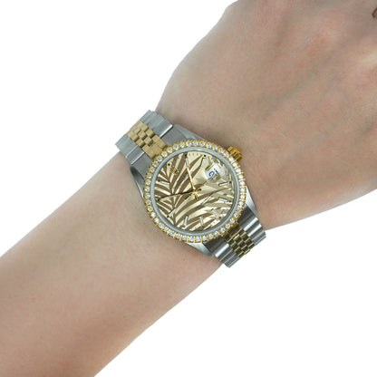Gold and silver watch on a wrist with a white background [lifestyle]