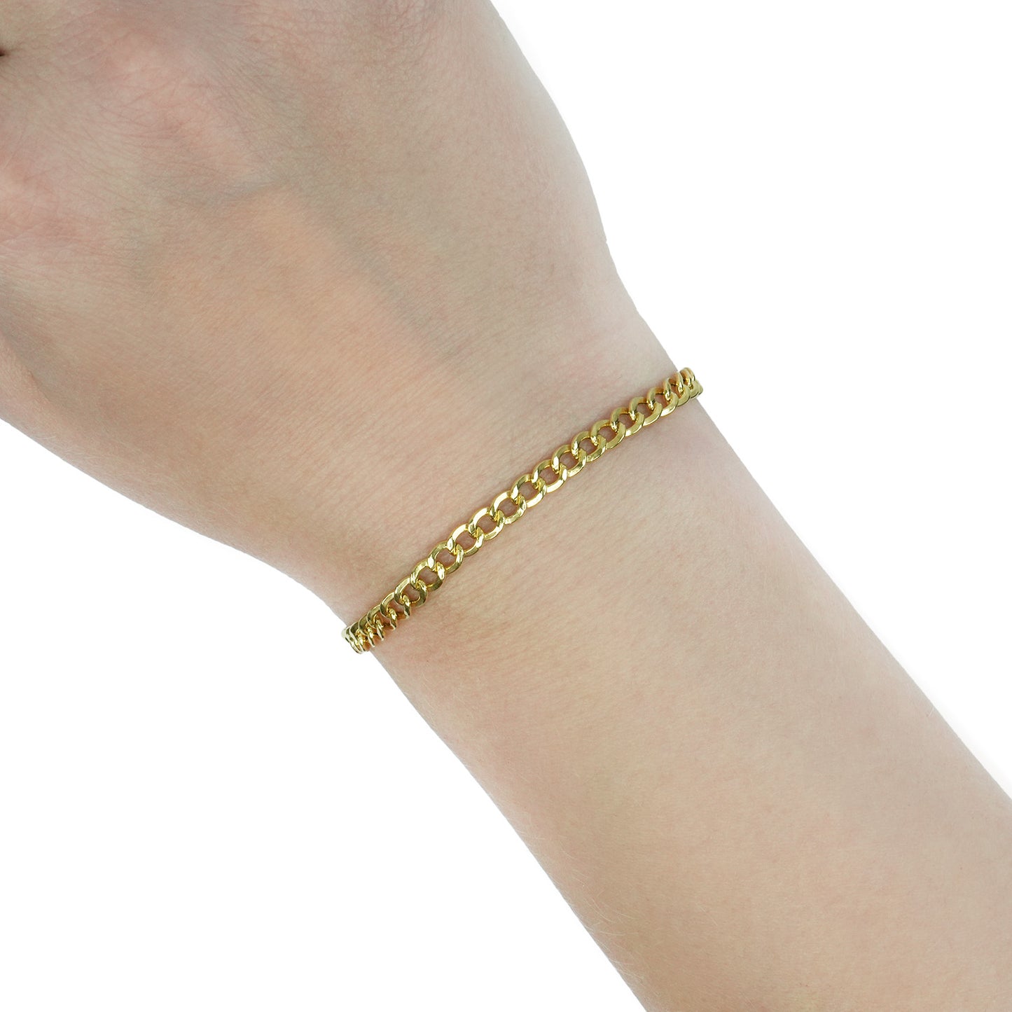 A gold curb chain bracelet worn on a person's wrist, shown against a plain white background. [lifestyle]