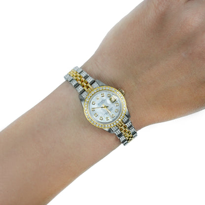 A two-tone stainless steel and yellow gold watch with a diamond bezel and matching link bracelet, shown worn on a person's wrist against a white background. [lifestyle]