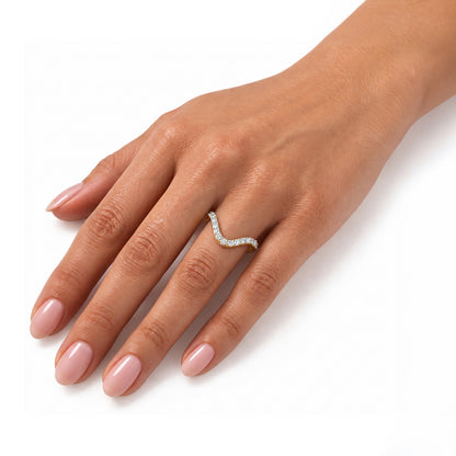 A close-up of a hand wearing a wavy, diamond-set ring on one finger, photographed against a clean white background. [lifestyle]