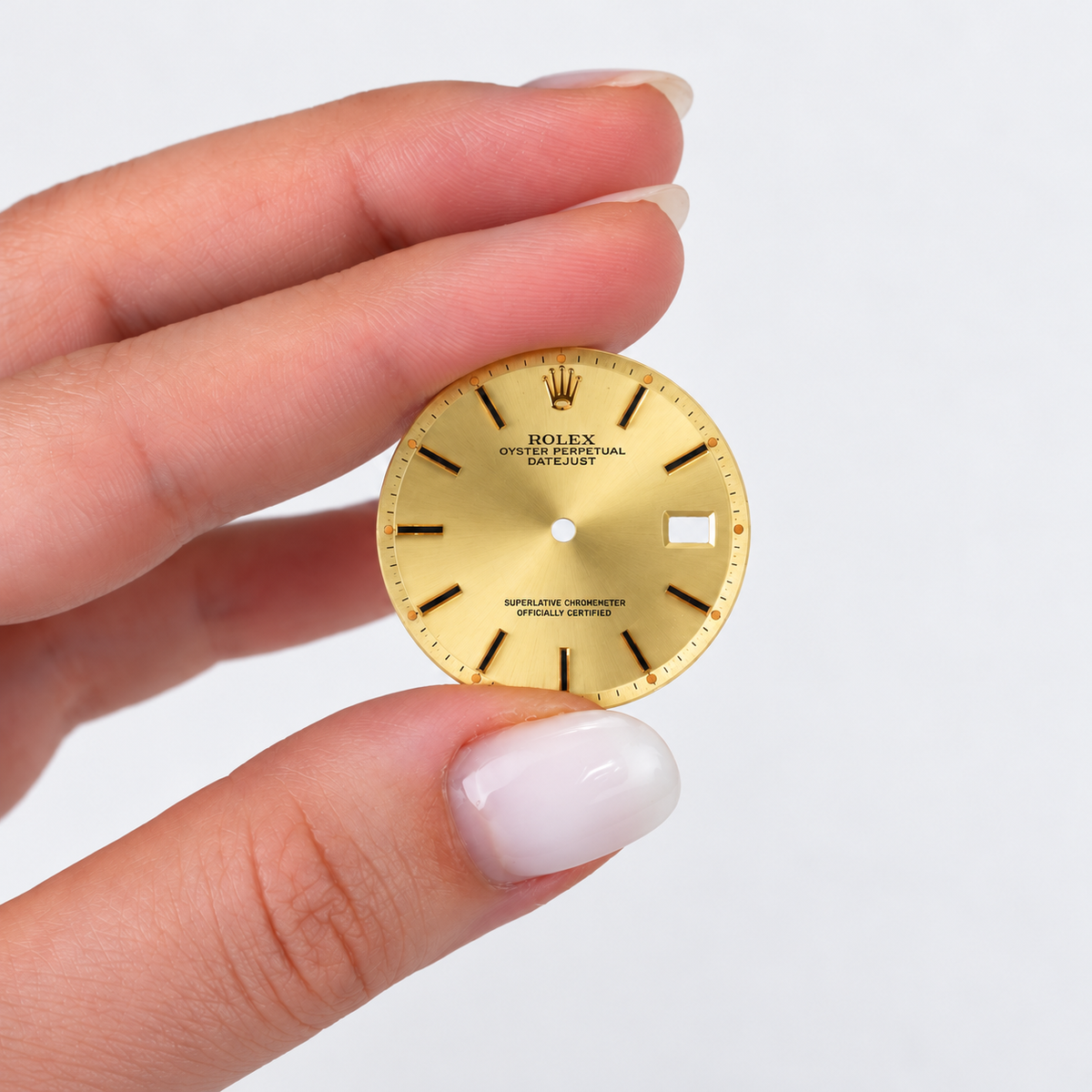 Rolex dial Style 14270 — hand-held actual dial, exposure corrected and square [lifestyle]