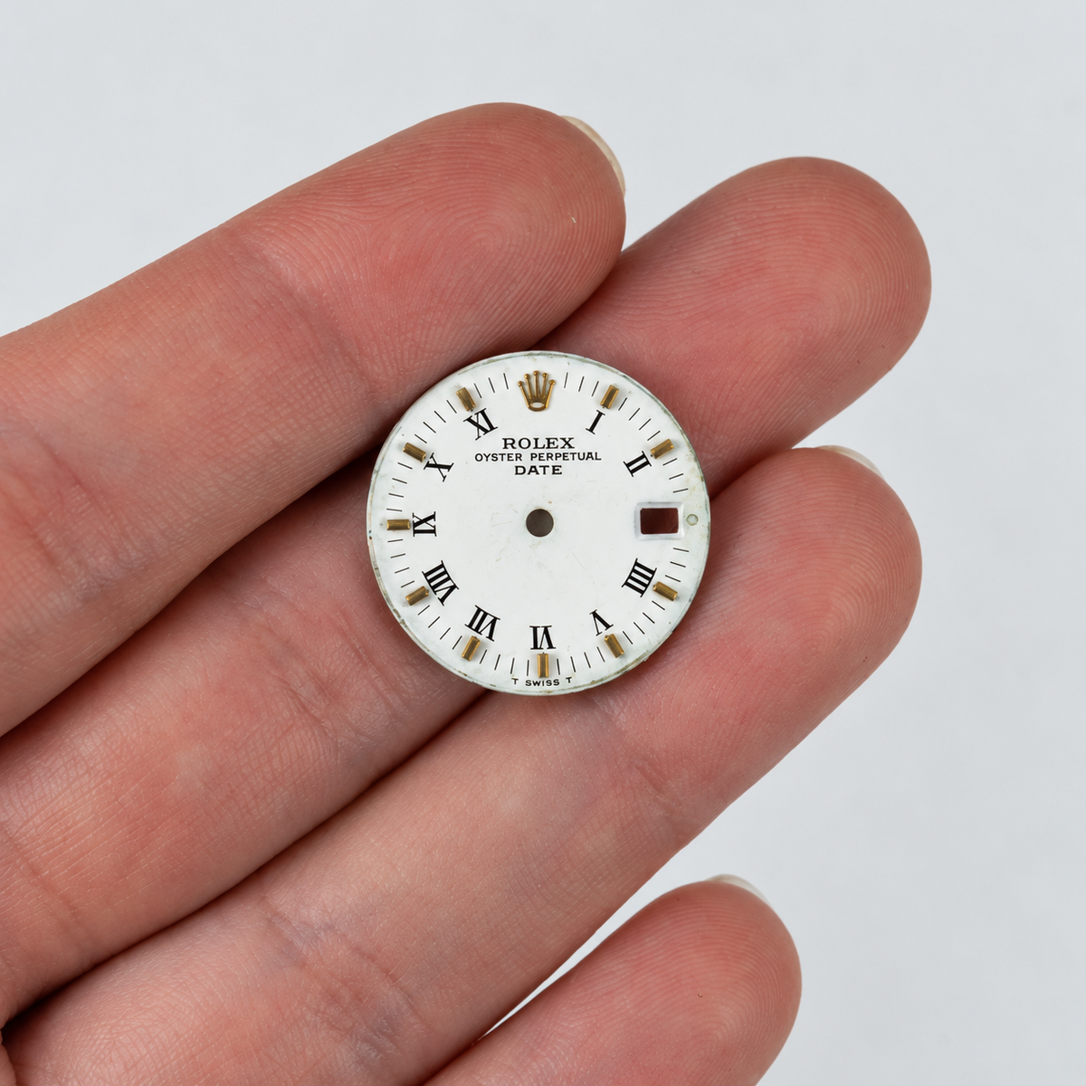 Rolex white matte dial Style 14273 — front-facing dial on fingers [lifestyle]