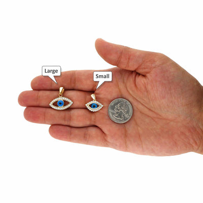 Hand holding yellow gold evil eye pendant necklace sizes with quarter for scale, large and small options visible.