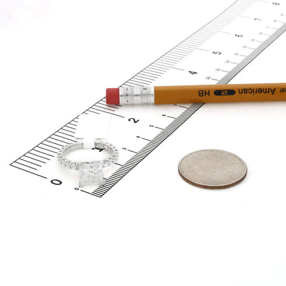 Lab-grown diamond engagement ring displayed next to a ruler and coin for size reference.