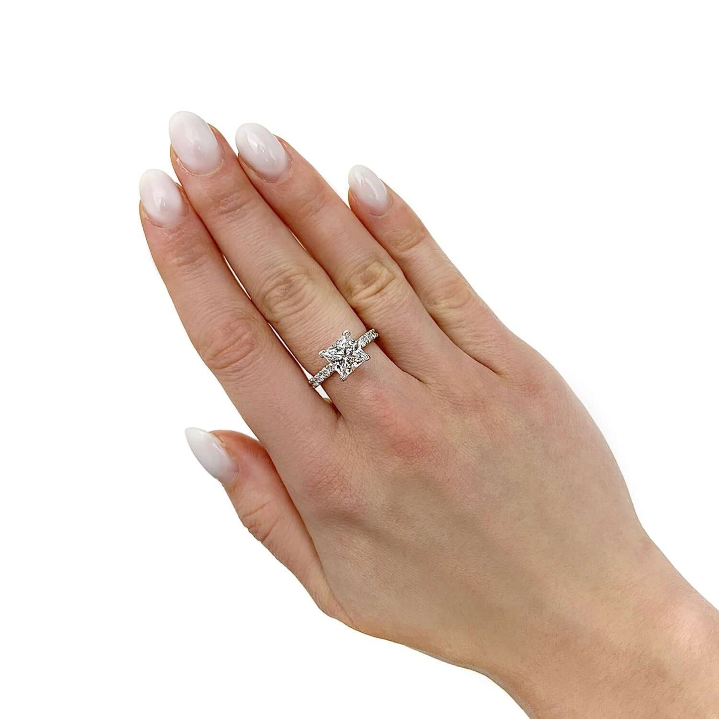 Hand wearing a 14K white gold lab-grown diamond engagement ring featuring a radiant-cut diamond.