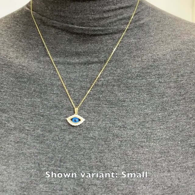 Yellow gold evil eye pendant necklace displayed on a model wearing a gray turtleneck, shown in small variant.