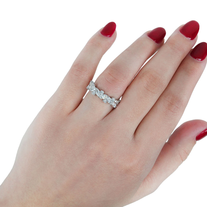 Hand wearing a diamond ring with red nail polish on a white background [lifestyle]