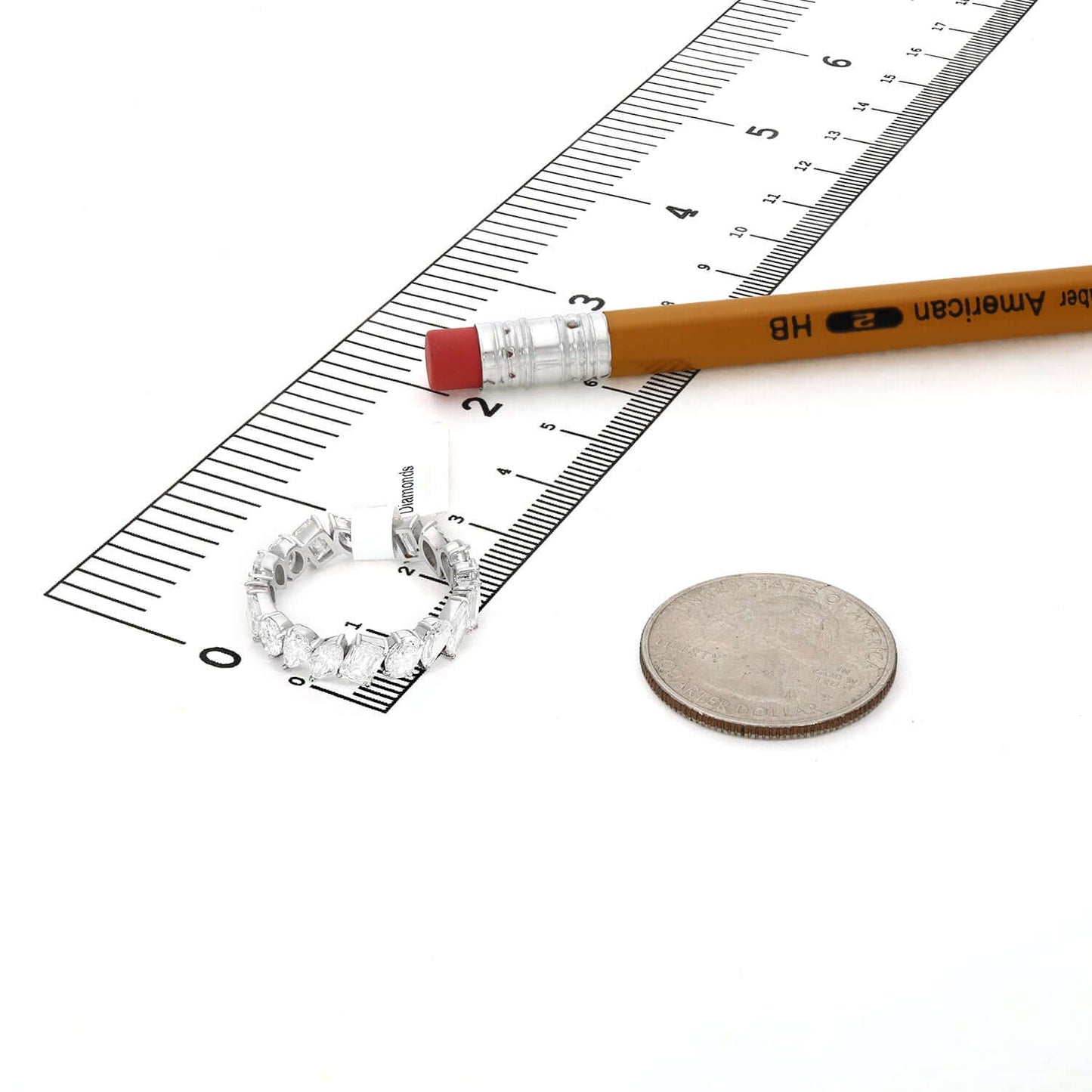 4.66 TCW Lab-Grown Diamond 14K White Gold Eternity Band next to a ruler and a coin for size reference.