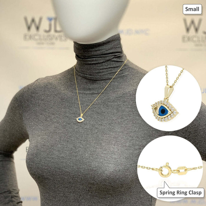 Yellow gold evil eye pendant necklace displayed on a model wearing a gray top, showing chain and clasp details.